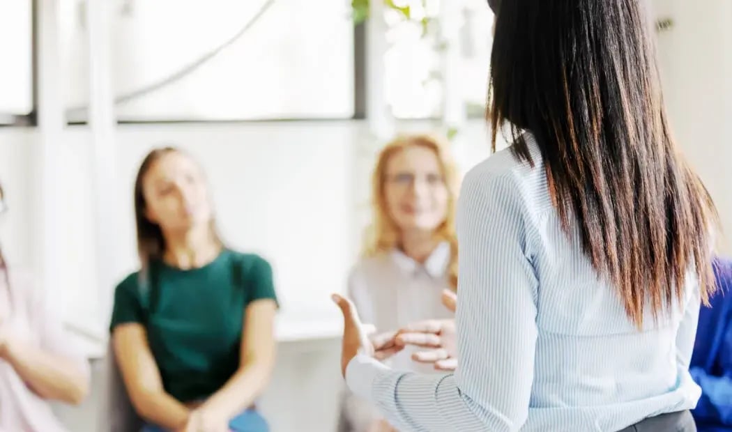 An advisor discussing workplace risks with financial services professionals An advisor discussing workplace risks with financial services professionals