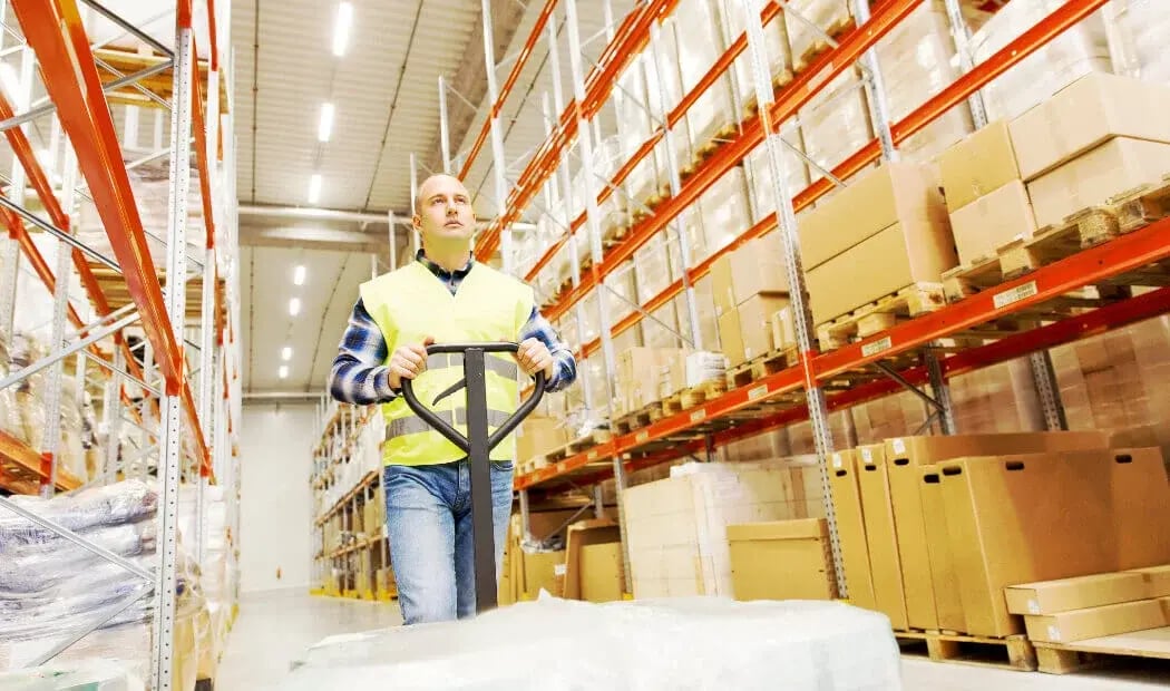 warehouse worker operating a pallet truck warehouse worker operating a pallet truck