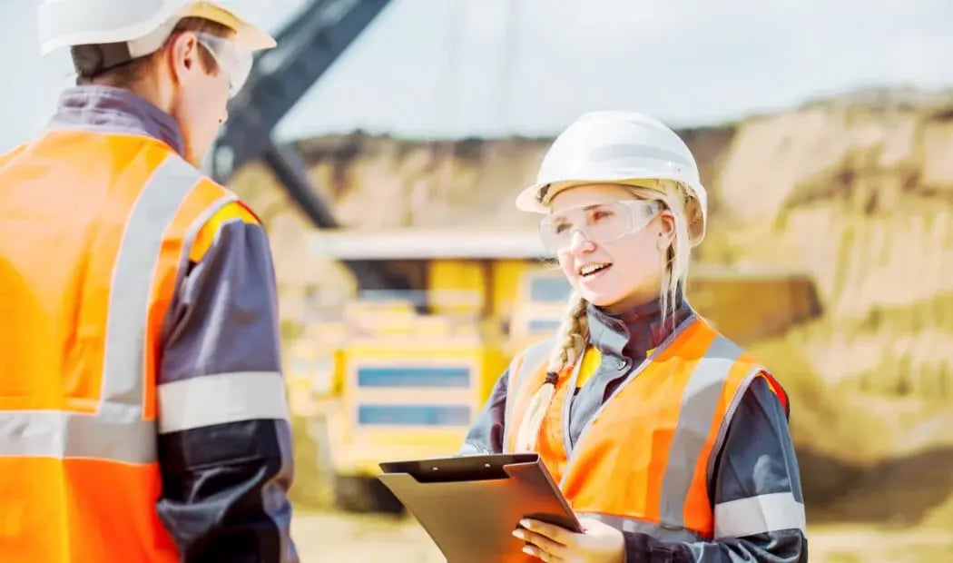 Two mining employees talking