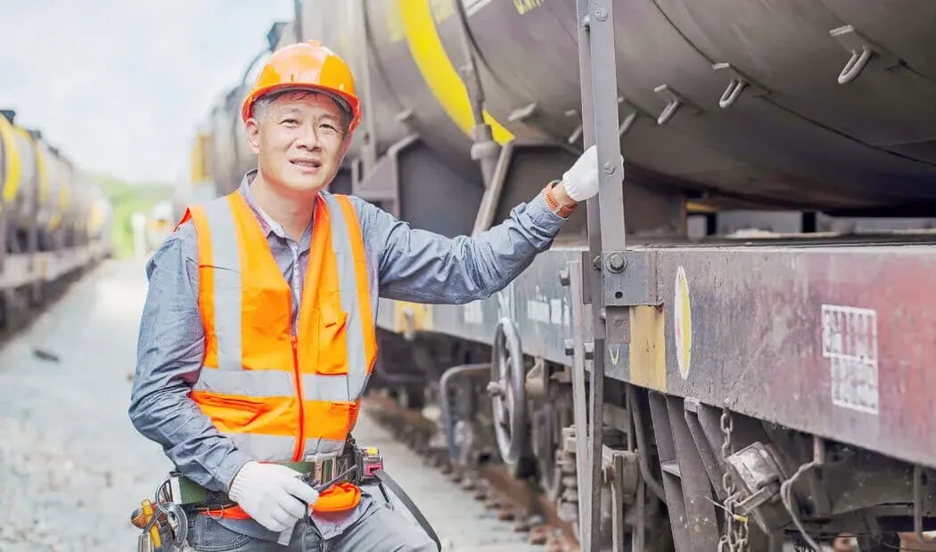 transport worker wearing PPE whilst working on a train carriage