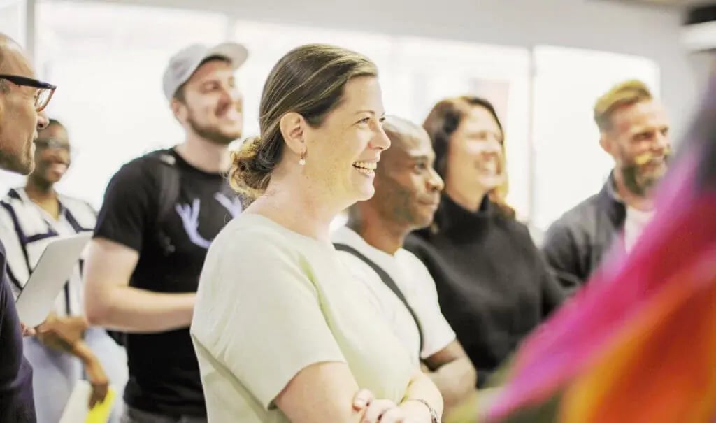 A group of standing people in a health workshop