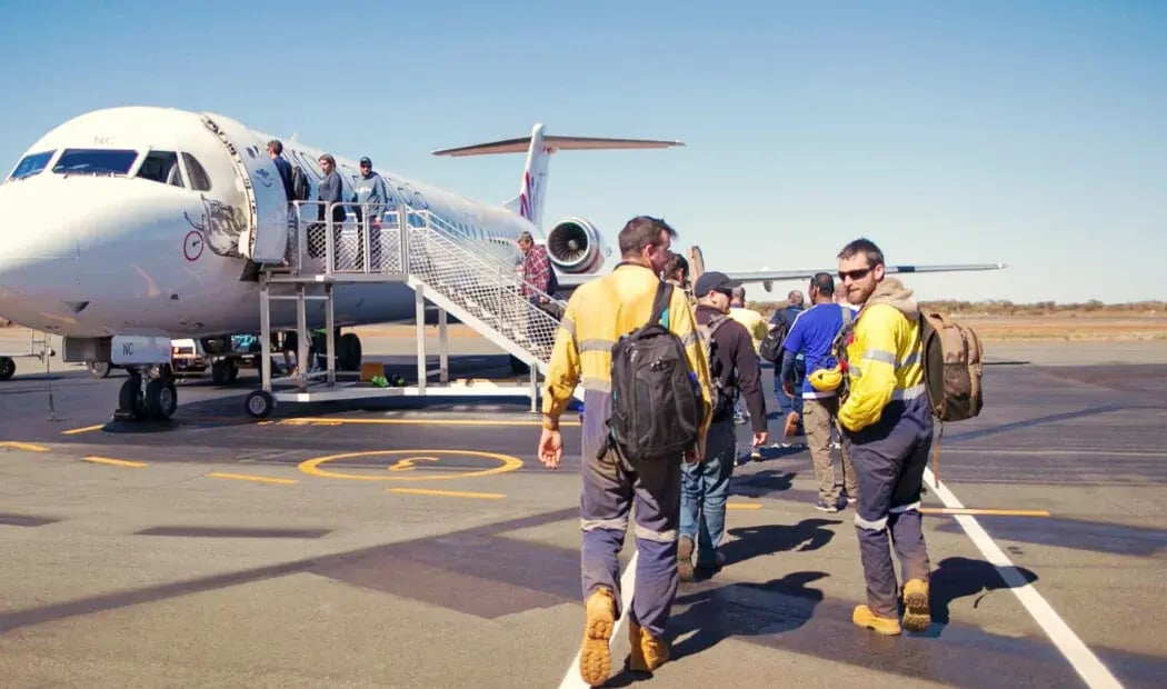 FIFO workers walking towards a plane FIFO workers walking towards a plane
