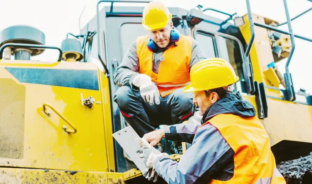 workers with PPE working with construction machinery workers with PPE working with construction machinery