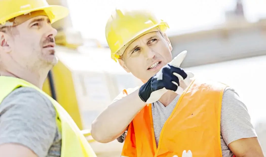 two FIFO workers in PPE in discussion two FIFO workers in PPE in discussion