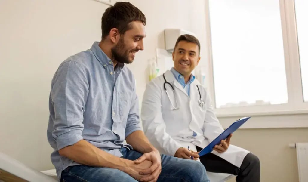 person and health professional sitting looking at clipboard person and health professional sitting looking at clipboard