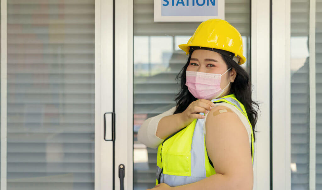 Employee with a Bandaid on arm after Vaccination