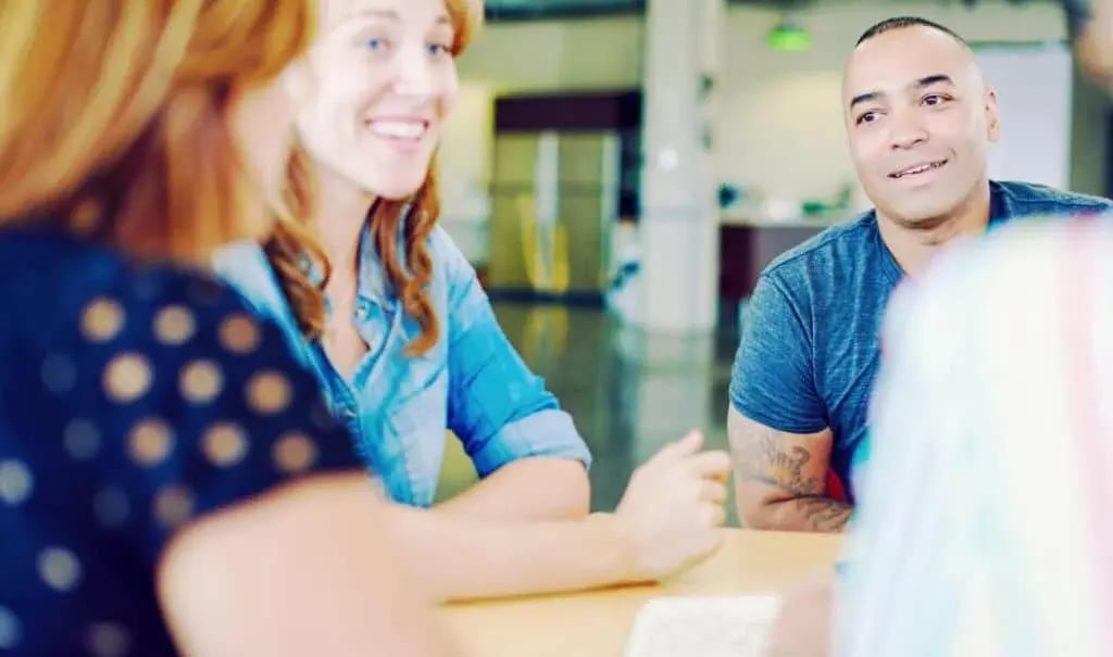 Work colleagues having a discussion around a table