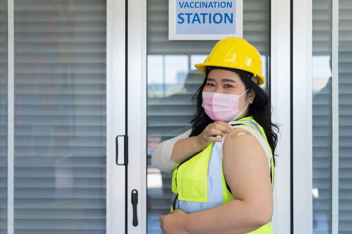 Employee with a bandaid on their arm after vaccination