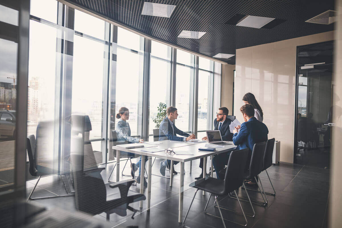 Suited people in an office meeting