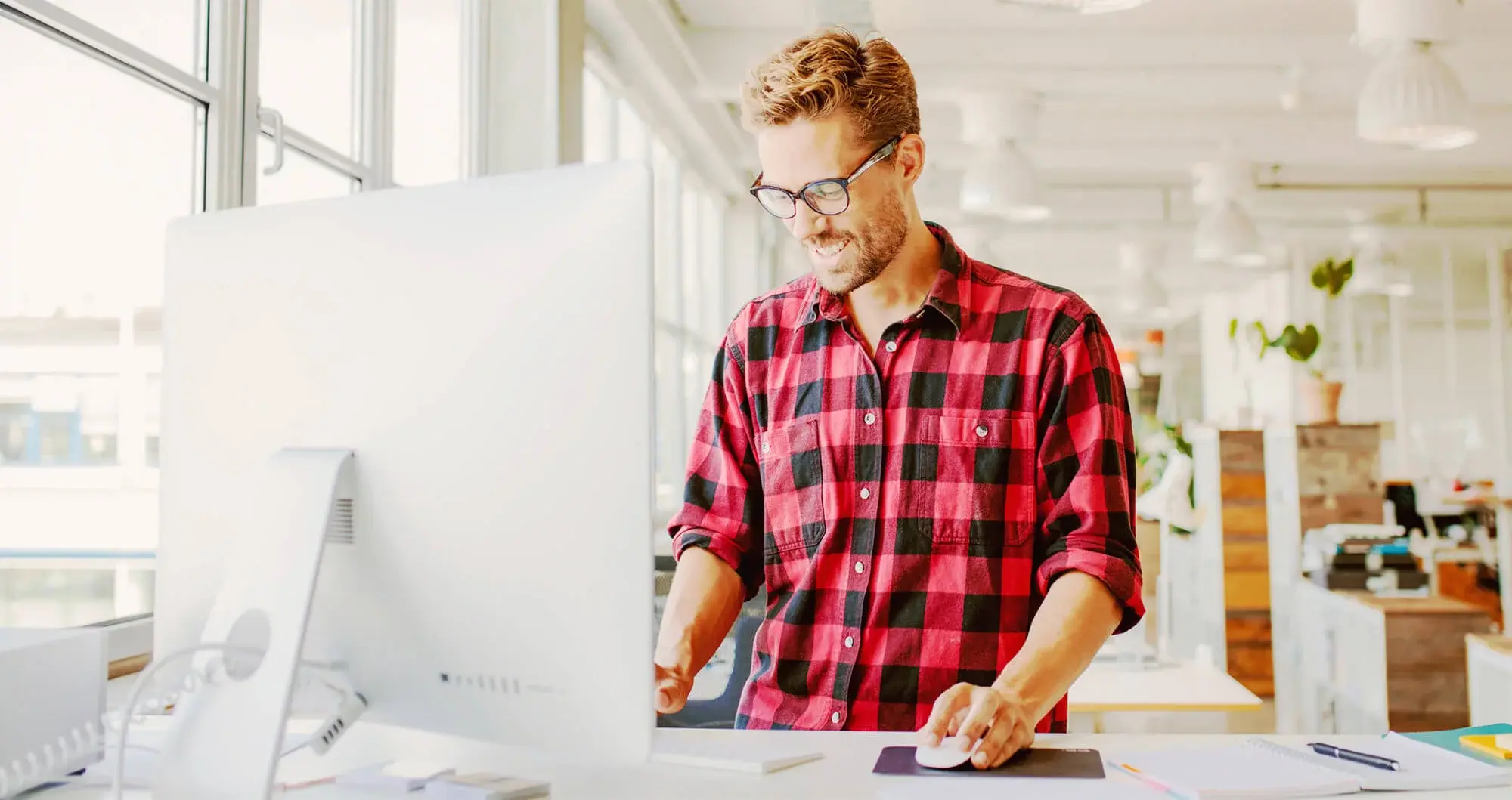 man working on a computer at an ergonomic workstation