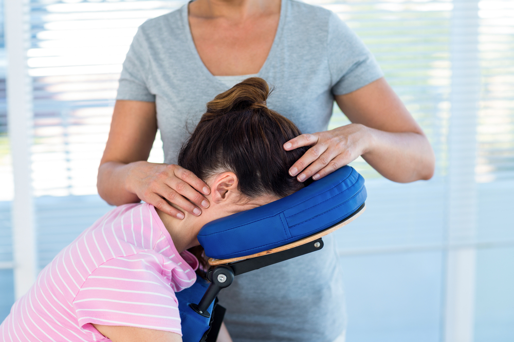 Woman having neck massage in medical office