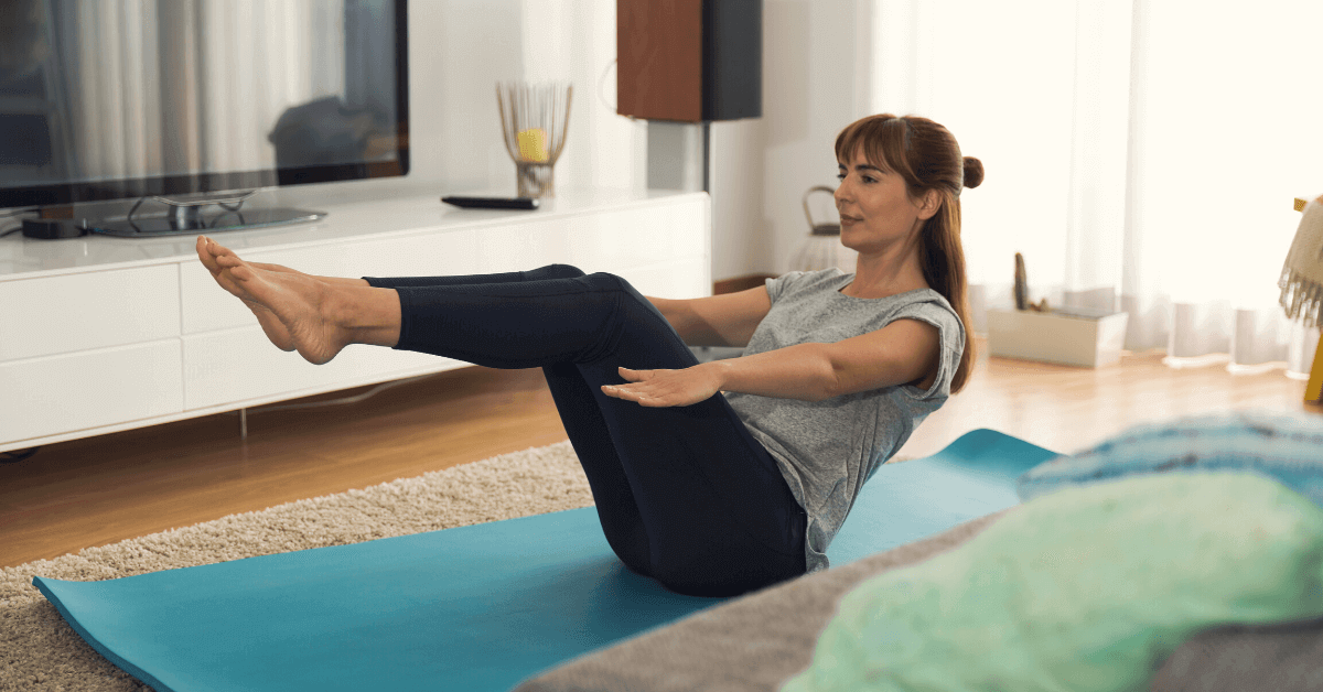 woman in a yoga pose at home on a yoga mat