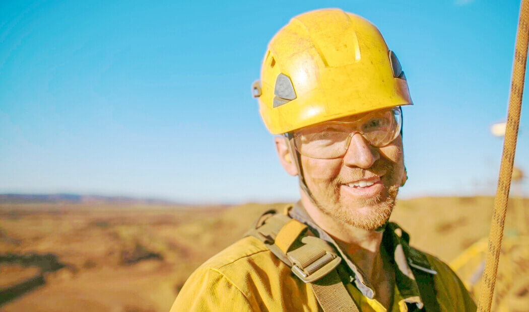 A smiling mining employee
