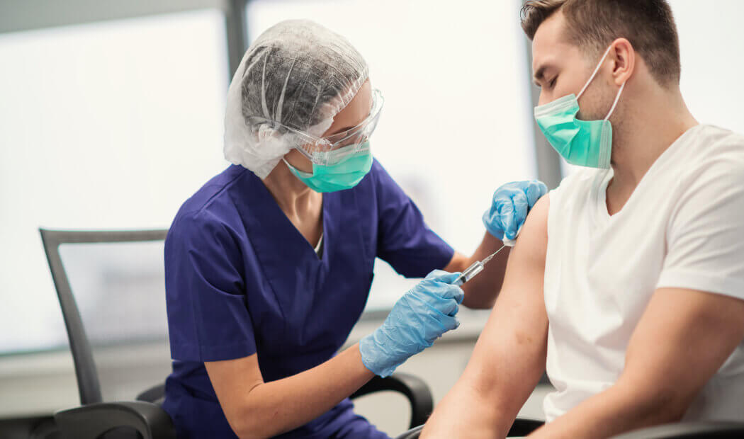 worker receiving a vaccination in the workplace