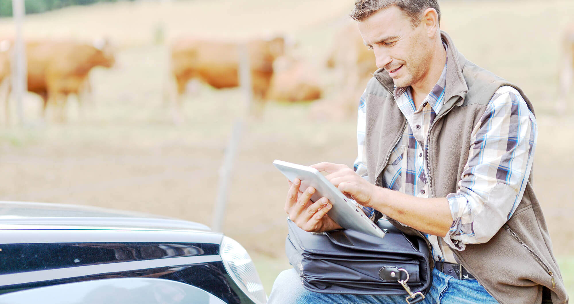 agricultural worker outdoors with tablet