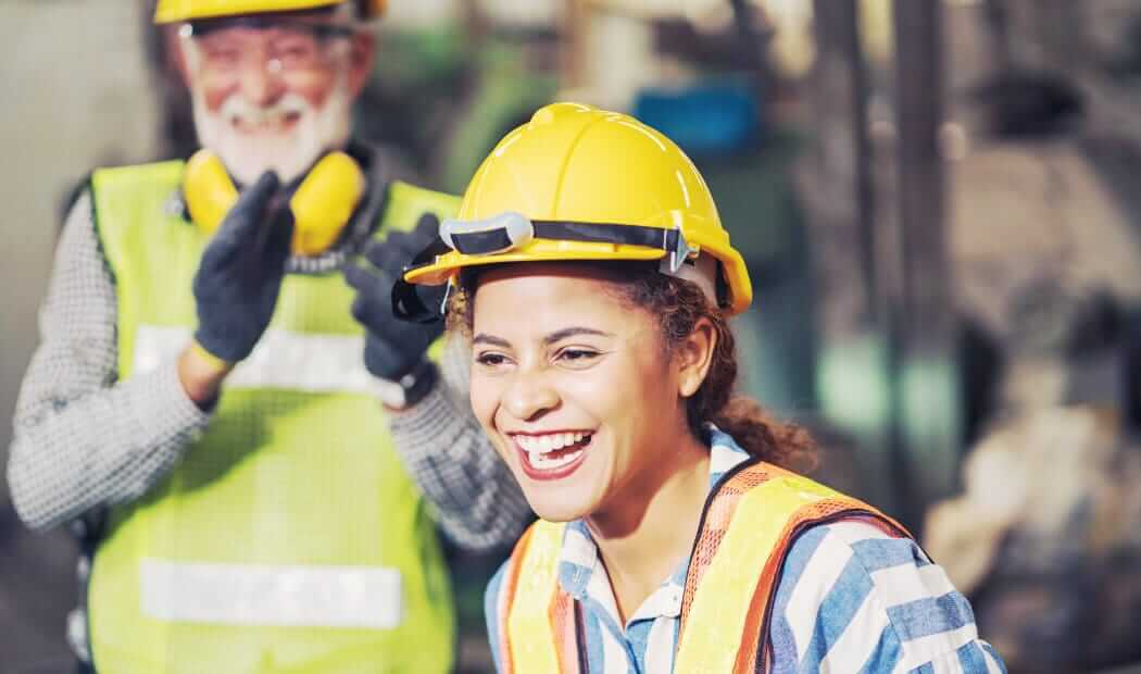 smiling, happy looking worker in PPE