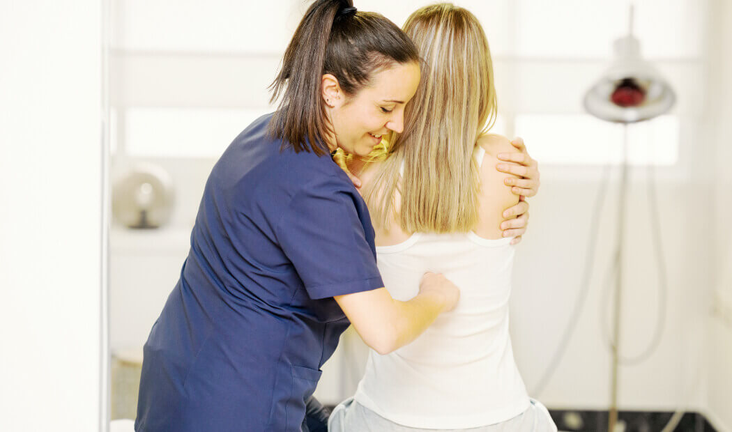 Female patient receiving physio for her back
