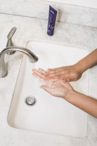 hands being washed over a sink