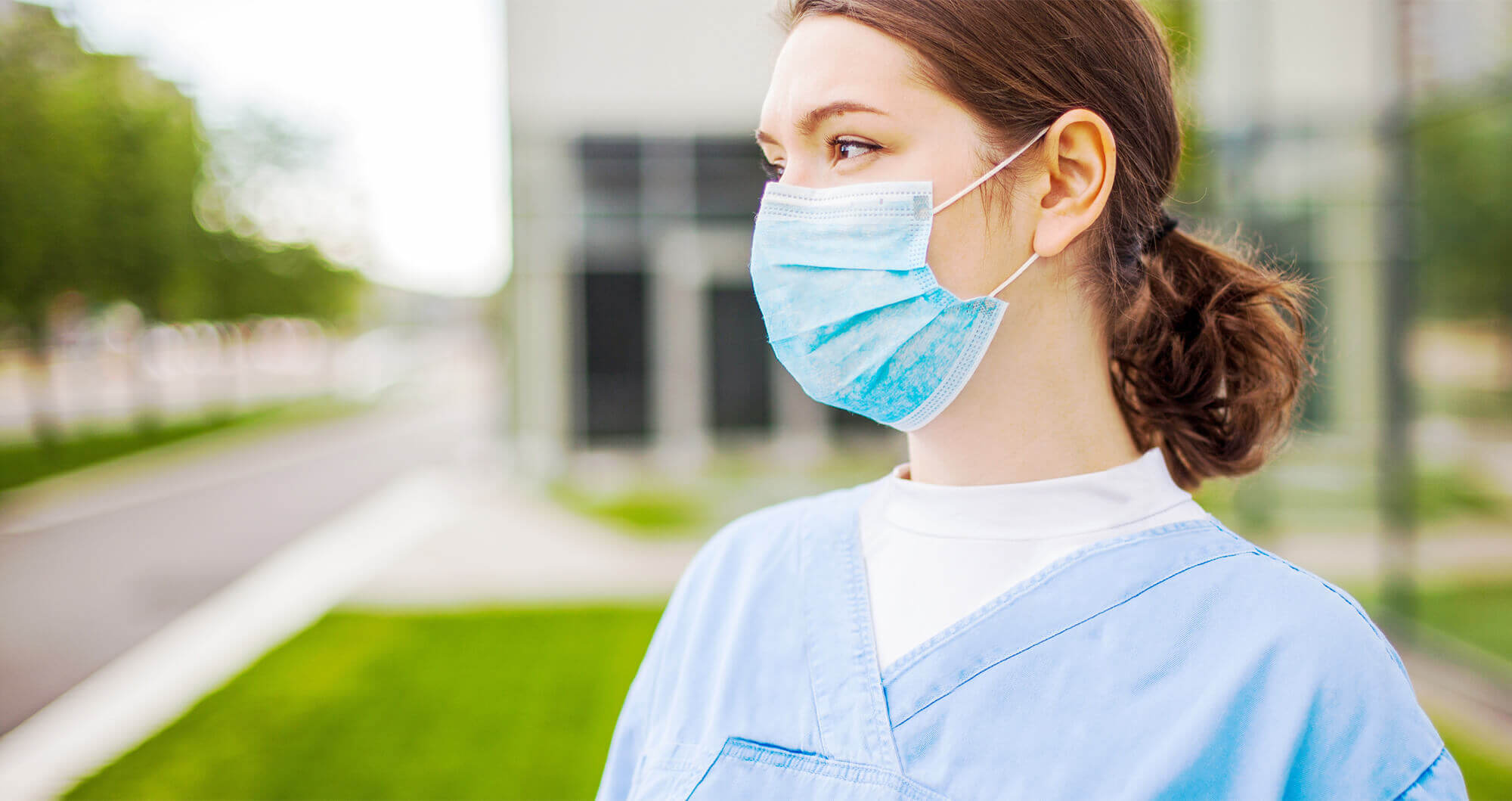 medical professional wearing scrubs and face mask