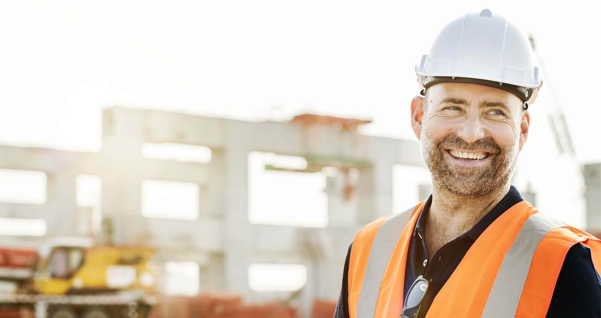 A smiling construction worker on-site
