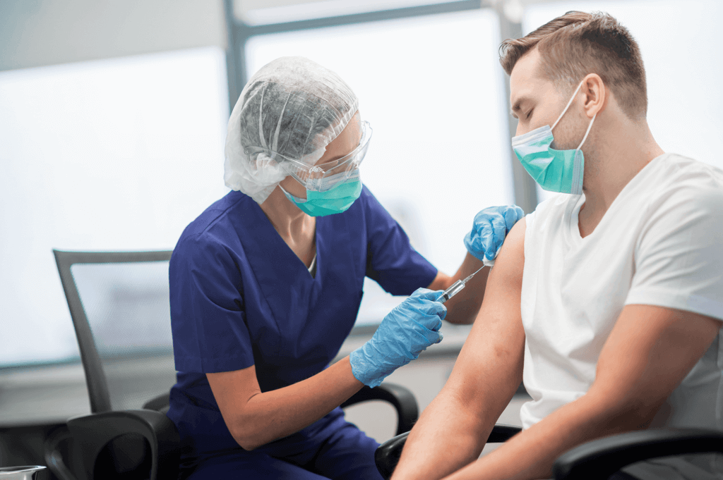 nurse administering a Covid vaccine